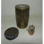 A white metal spice shaker together with