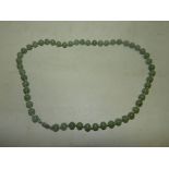 A uniform jade bead necklace.*