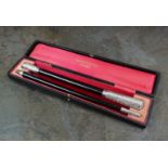 A cased silver mounted conductors baton,