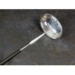 A white metal toddy ladle with turned wh