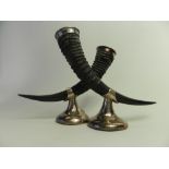 A pair of white metal mounted horn pounc