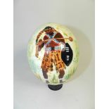 A painted ostrich egg on stand