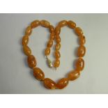 A graduated orange bead necklace