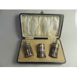 A cased set of three silver condiments c