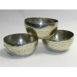 A set of three Eastern white metal bowls with engraved decoration