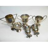 A collection of five silver two handled presentation trophy cups, four with engraved presentations,