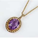 An amethyst and split pearl set pendant, designed as an oval mixed cut amethyst claw set within a