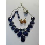 A suite of lapis lazuli set jewellery comprising a necklace, a pair of drop earrings and a ring,