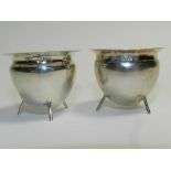 A pair of silver salts hallmarked Chester 1905 in the style of Christopher Dresser each of caldron