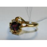 A garnet and white stone set dress ring*