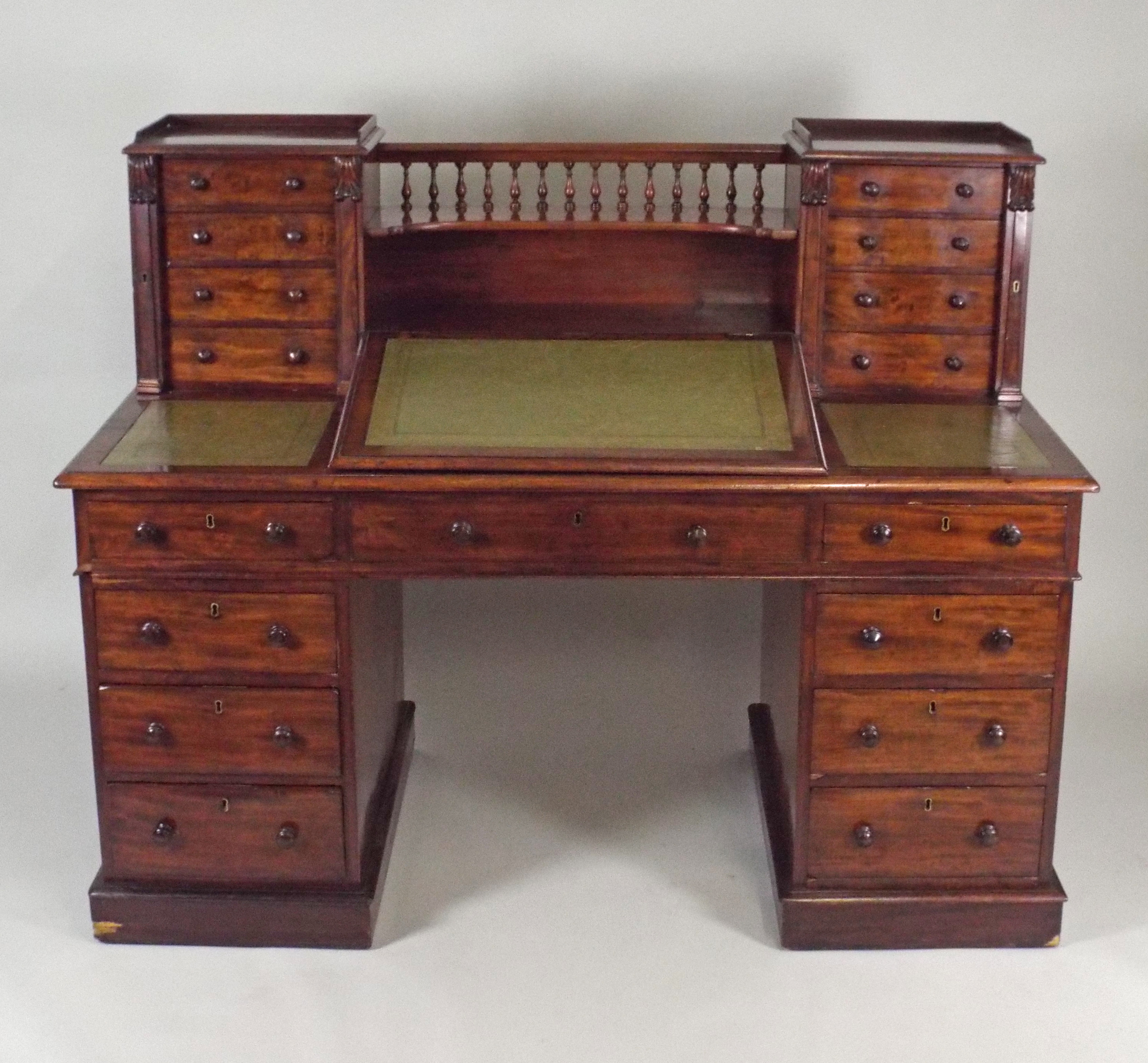A Victorian mahogany pedestal desk the back superstructure of a spindle galleried concaved open