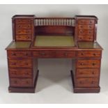 A Victorian mahogany pedestal desk the back superstructure of a spindle galleried concaved open
