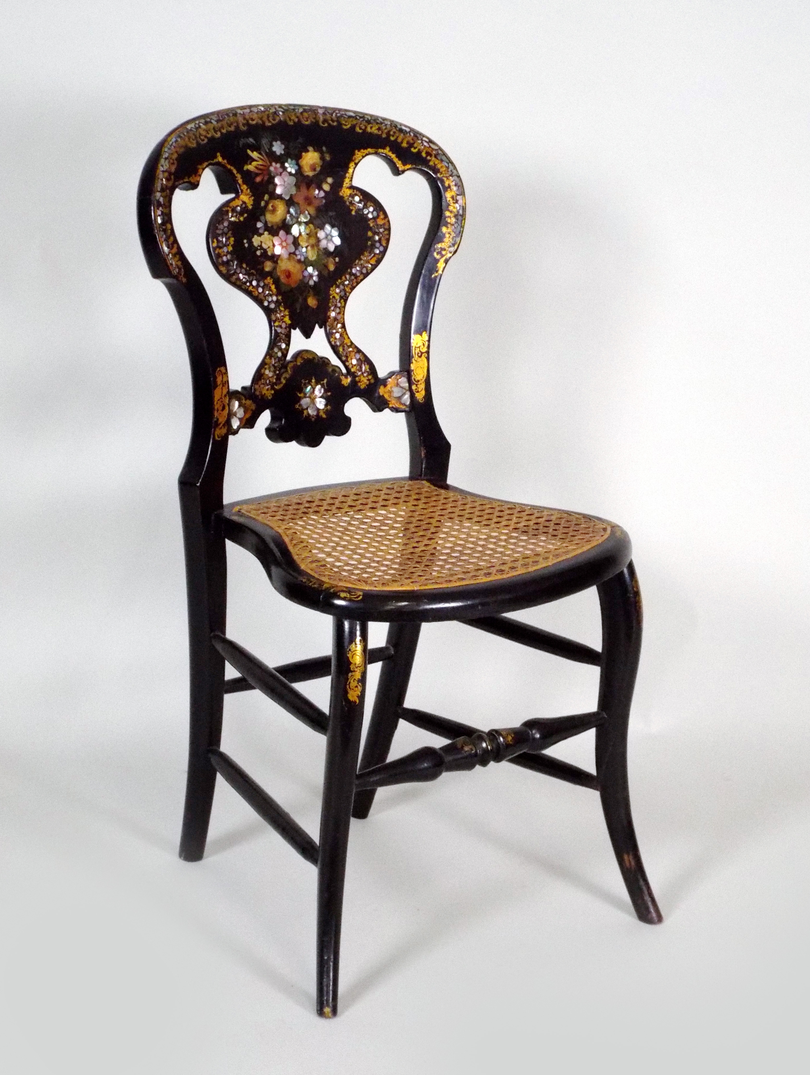 A Victorian ebonised polychrome decorated abalone inlaid and gilt highlighted bedroom chair with