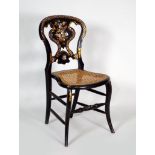 A Victorian ebonised polychrome decorated abalone inlaid and gilt highlighted bedroom chair with