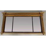 A Regency landscape overmantel mirror the three rectangular mirror plates within an ebonised slip,