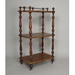 A late Victorian walnut three tier what-not, of rectangular form, with slender turned corner