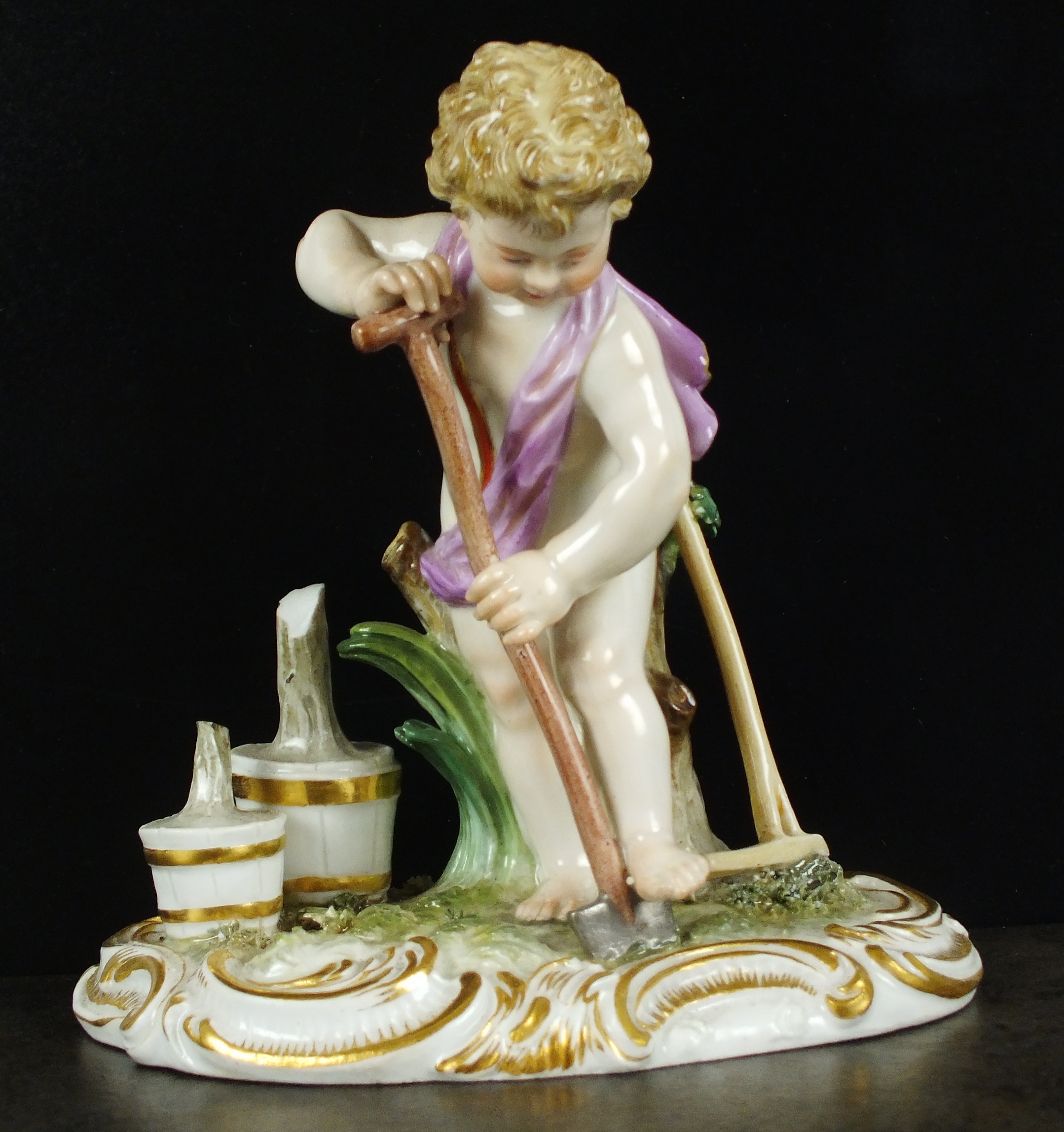 A 19th century Meissen figure, the first modelled as a gardener, the young, semi-clad boy digging