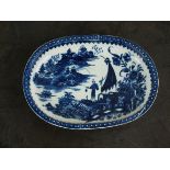 A Caughley oval baking dish, circa 1780-90, transfer printed in underglaze blue with the Fisherman
