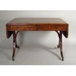 A Regency rosewood sofa table, with gilded beaded gilt metal mounts and inlaid edge, the