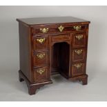 A George II style mahogany boxwood line strung and crossbanded kneehole desk, the rectangular top