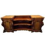 A mid Victorian mahogany inverted breakfront pedestal sideboard, the two pedestals with rounded