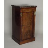 A 19th century mahogany French Empire style night cupboard, the variegated marble top over a flame