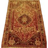 A Northwest Persian red and blue ground rug with central lozenge motif 245cm x 164cm