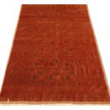 A late 20th century red ground Turkestan rug 288cm x 200cm
