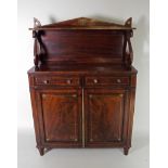 A Regency rosewood brass line strung two door chiffonier with pointed arch back and open shelf over