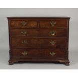 A George III mahogany chest of two short over three long graduated cockbeaded drawers fitted with