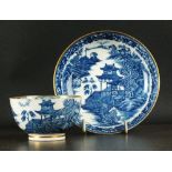 A Caughley tea bowl and saucer, circa 1780-90, transfer-printed in underglaze blue with the Fenced