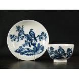 A Caughley tea bowl and saucer, circa 1785, transfer-printed in underglaze blue with the Birds in