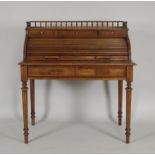 An early 20th century French walnut tambour top writing desk, the galleried back over three short