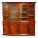 A 19th century mahogany breakfront bookcase cabinet, the ogee moulded cornice over four glazed