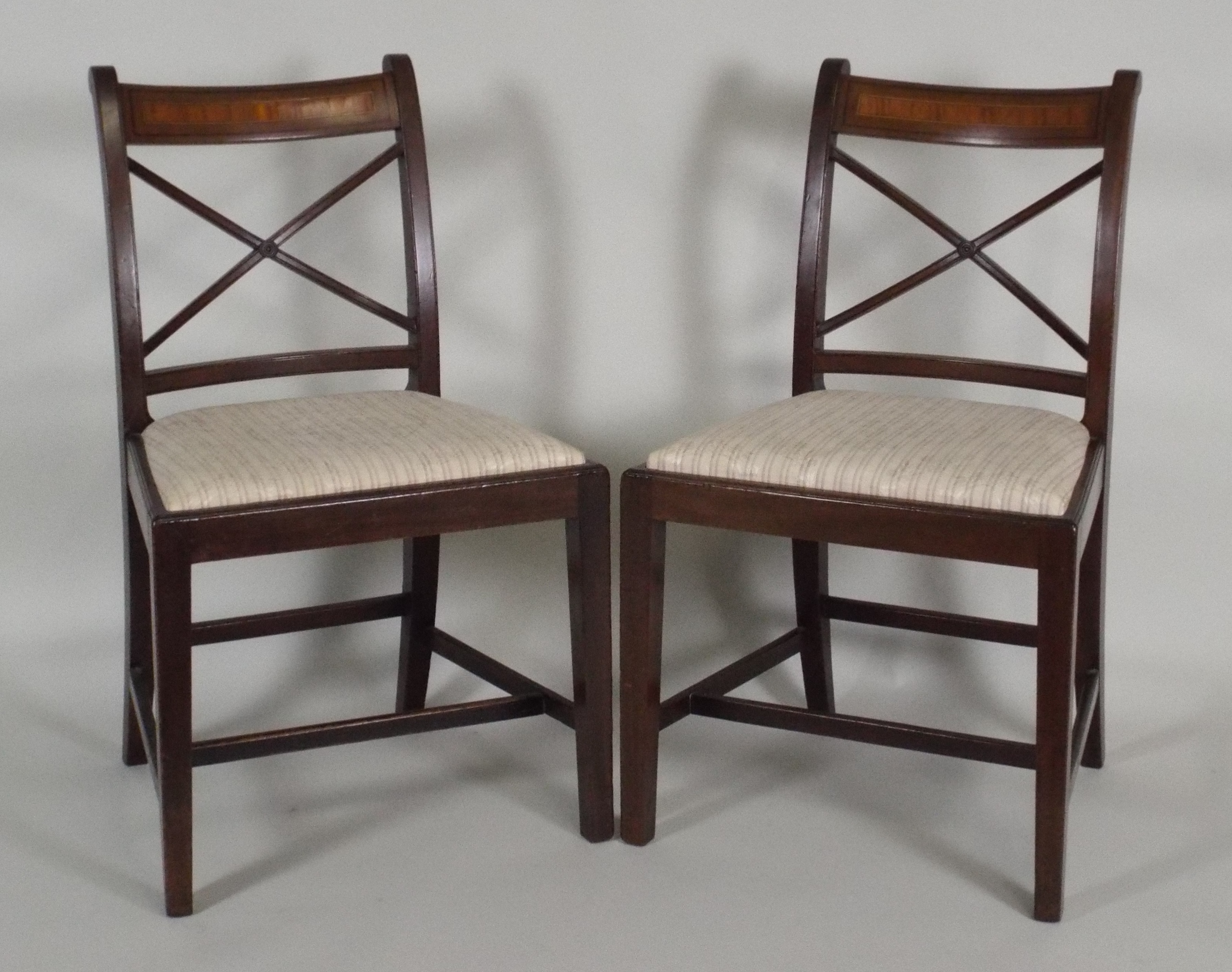 A set of six early 19th century mahogany country Sheraton dining chairs each with satinwood centred