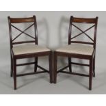 A set of six early 19th century mahogany country Sheraton dining chairs each with satinwood centred