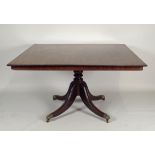 A George IV mahogany triple pillar dining table the rectangular top with moulded edge and drop-leaf