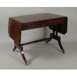A Regency mahogany ebony line strung sofa table, the rectangular top with cut off corners to the