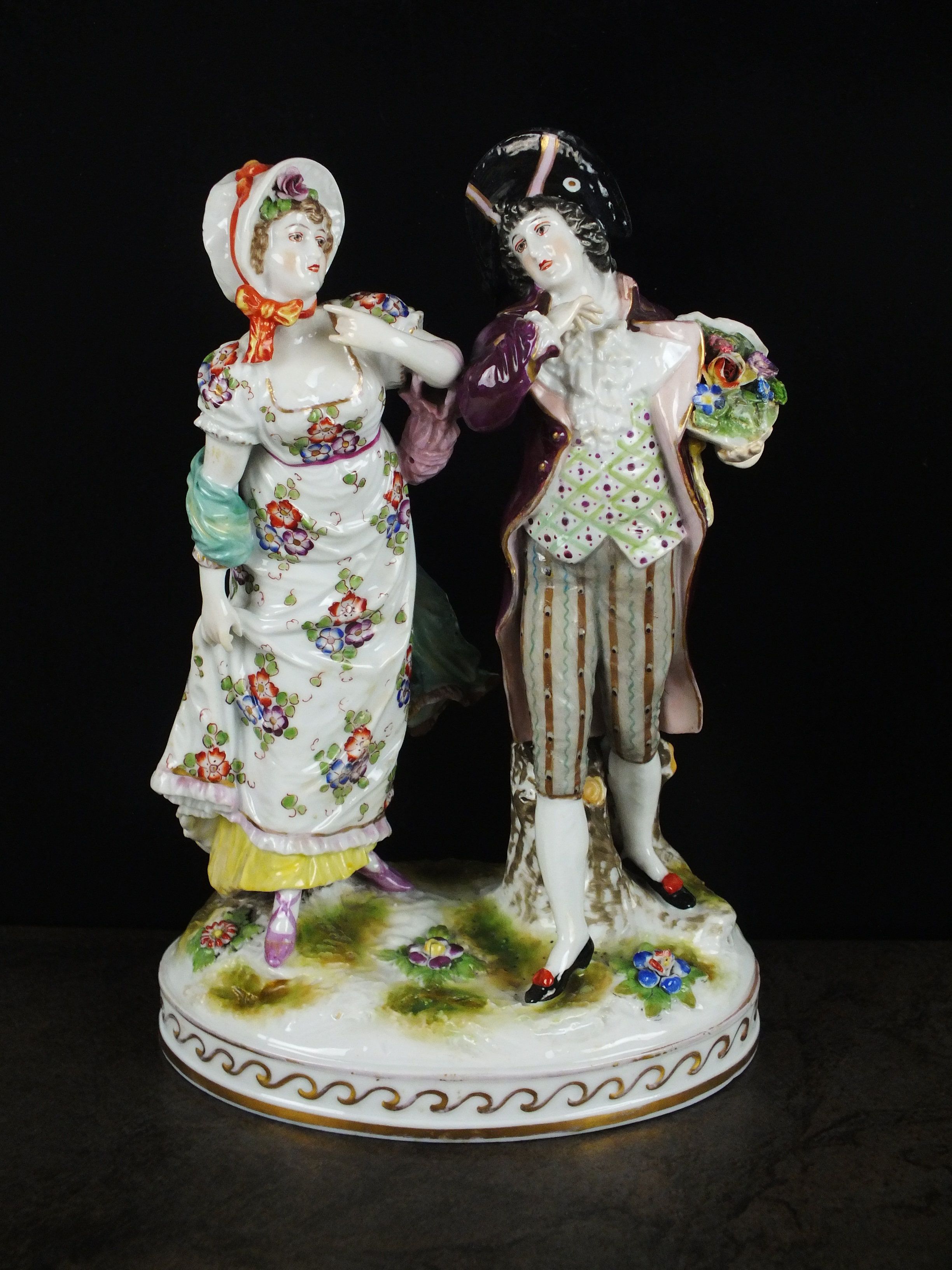 A Rudolstadt Volkstedt porcelain figural group, 20th century, modelled as gallant and companion, on