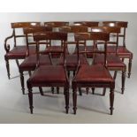 A set of nine William IV mahogany dining chairs including one carver, each with a rounded bar back