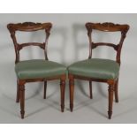 A set of six early Victorian rosewood and faux grained dining chairs, each with a scroll carved top