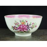 A Caughley polychrome tea bowl, circa 1785-90, painted with flowers, below a red line and purple