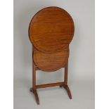 An Edwardian and satinwood boxwood and ebony line strung two tier folding circular tea table, the