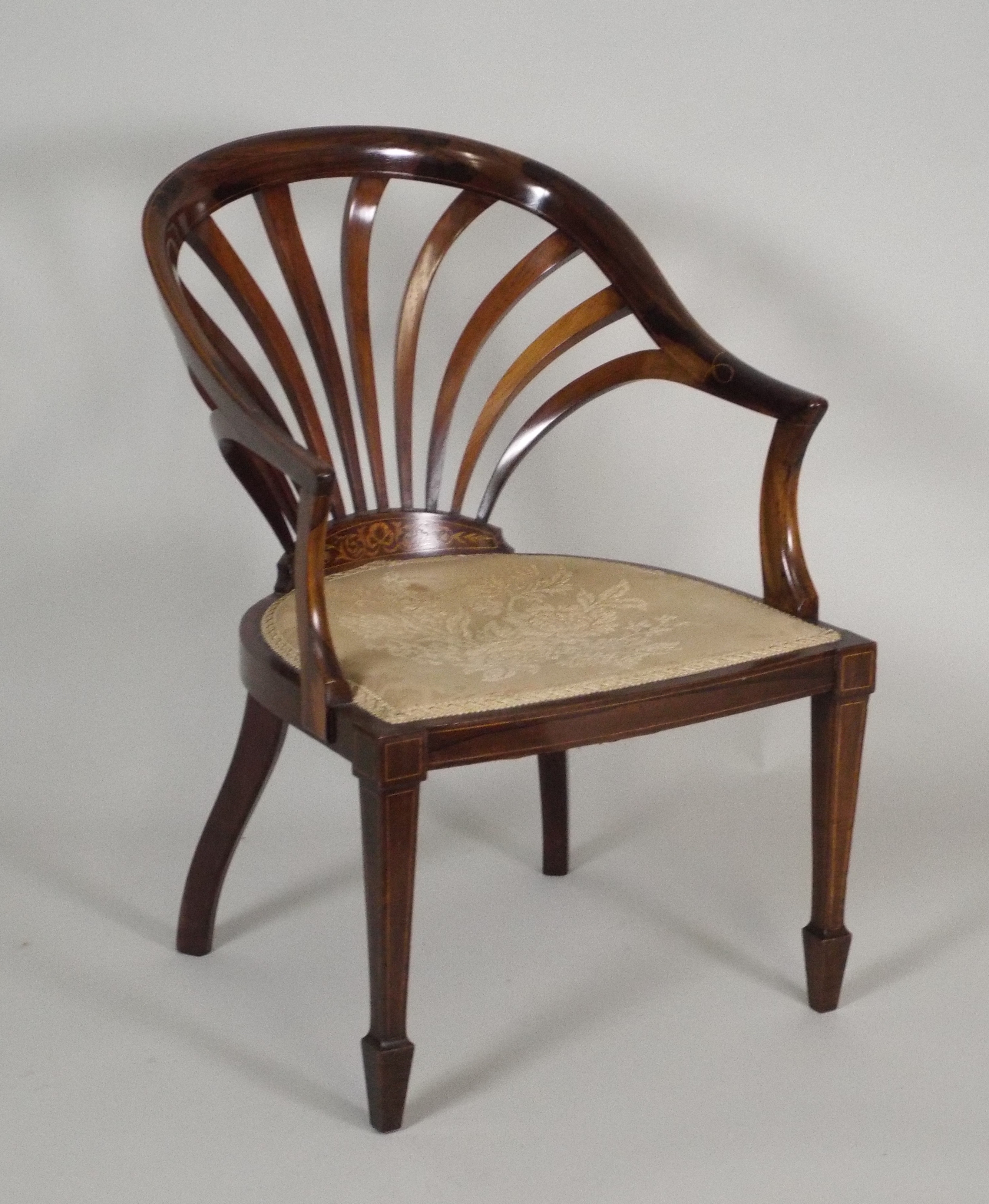 A late 19th/early 20th century rosewood and marquetry boxwood line strung, low tub chair, with fan