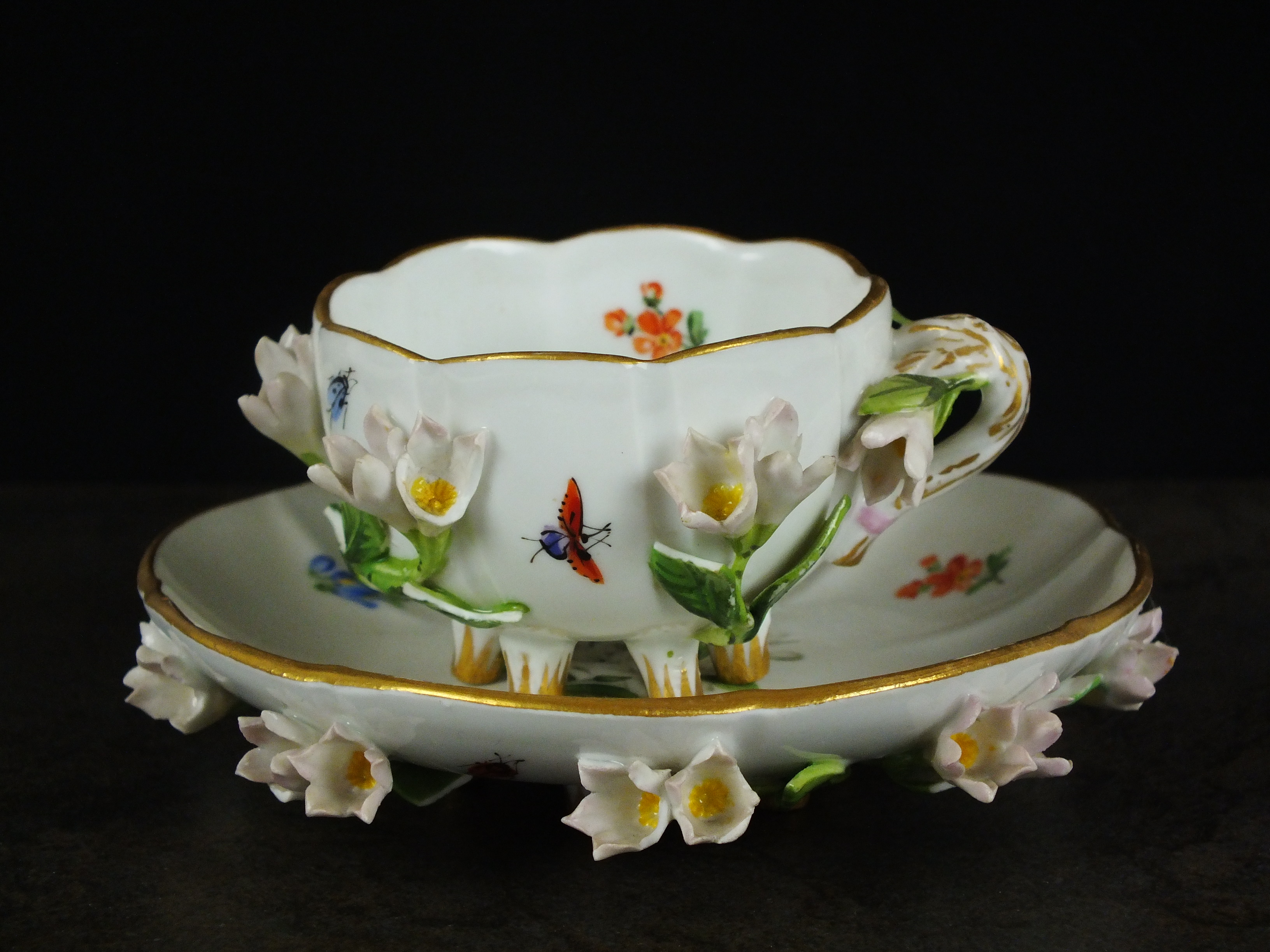 A Meissen porcelain cup and saucer, late 19th century/20th century, decorated with flowers in