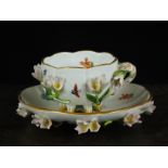 A Meissen porcelain cup and saucer, late 19th century/20th century, decorated with flowers in