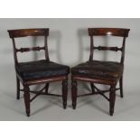 A pair of Regency mahogany library side chairs each with a bar back with flowerhead and line carved