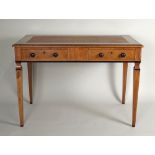 A 20th century walnut two drawer writing table, the rectangular top tulip wood crossbanded within a