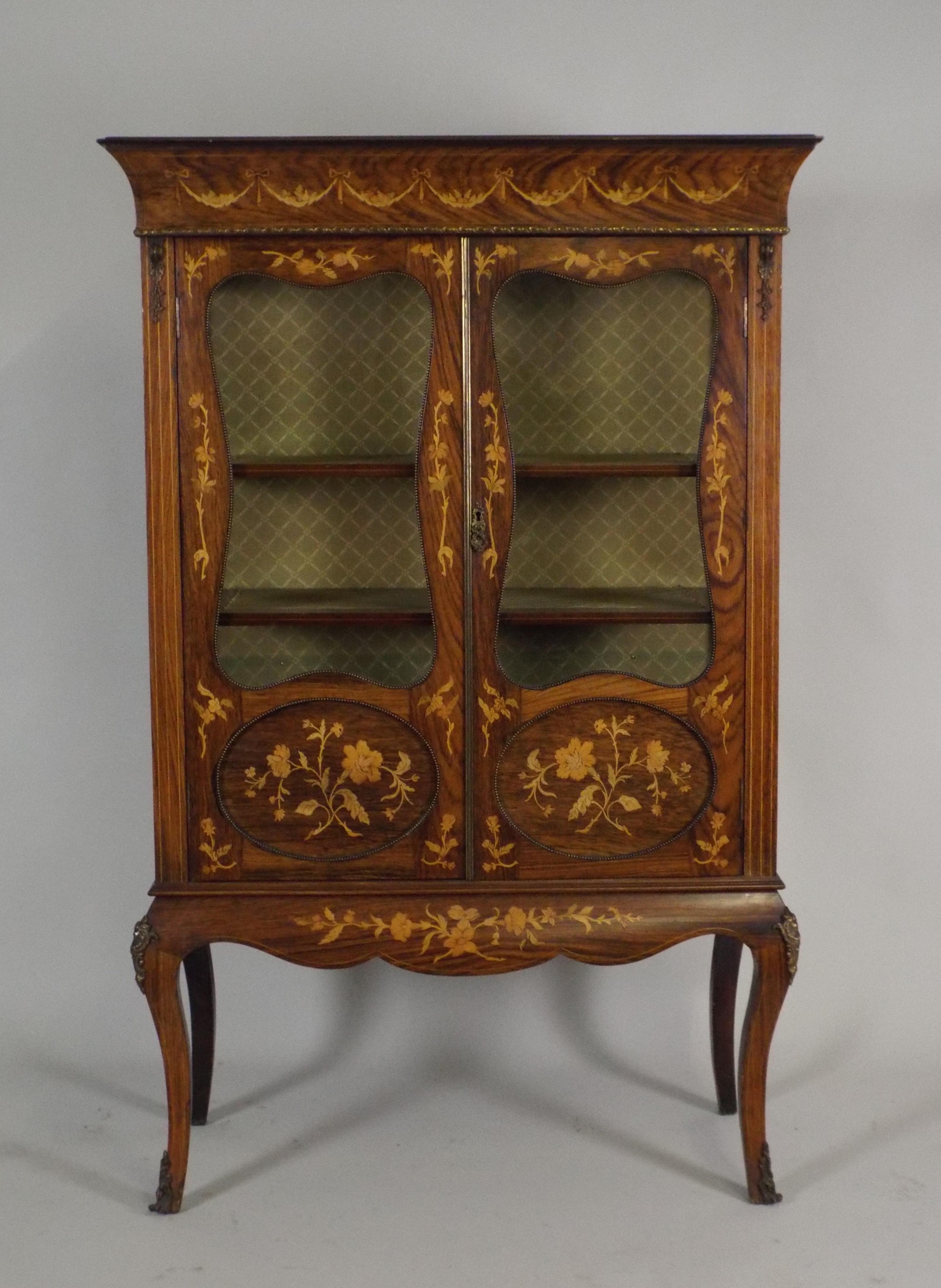 A Louis XV style faux rosewood and marquetry low china display cabinet the flared cornice with