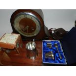 A 1950s oak cased mantel clock together with a christening set,